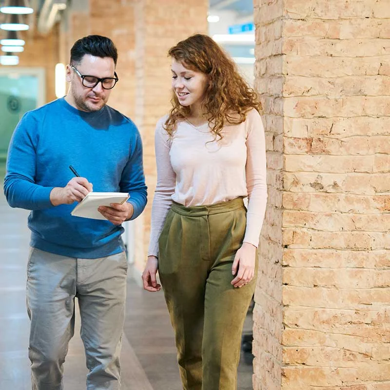 Two people reviewing technology information
