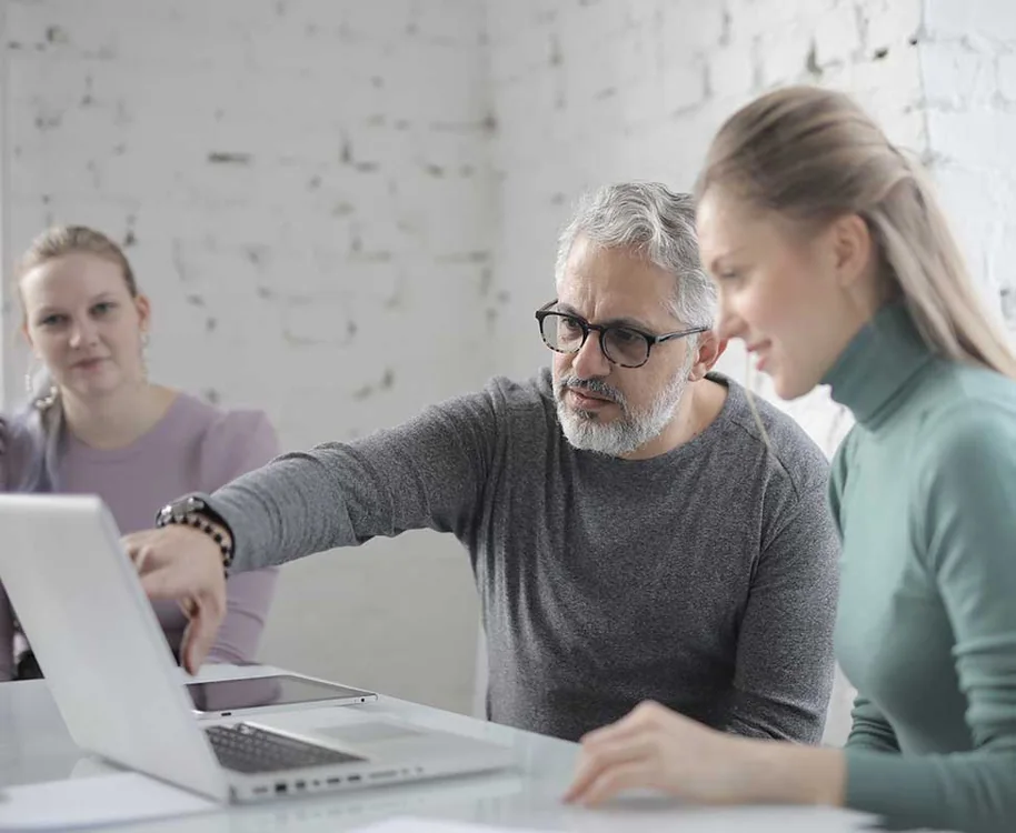 Business colleagues reviewing requirements at a computer